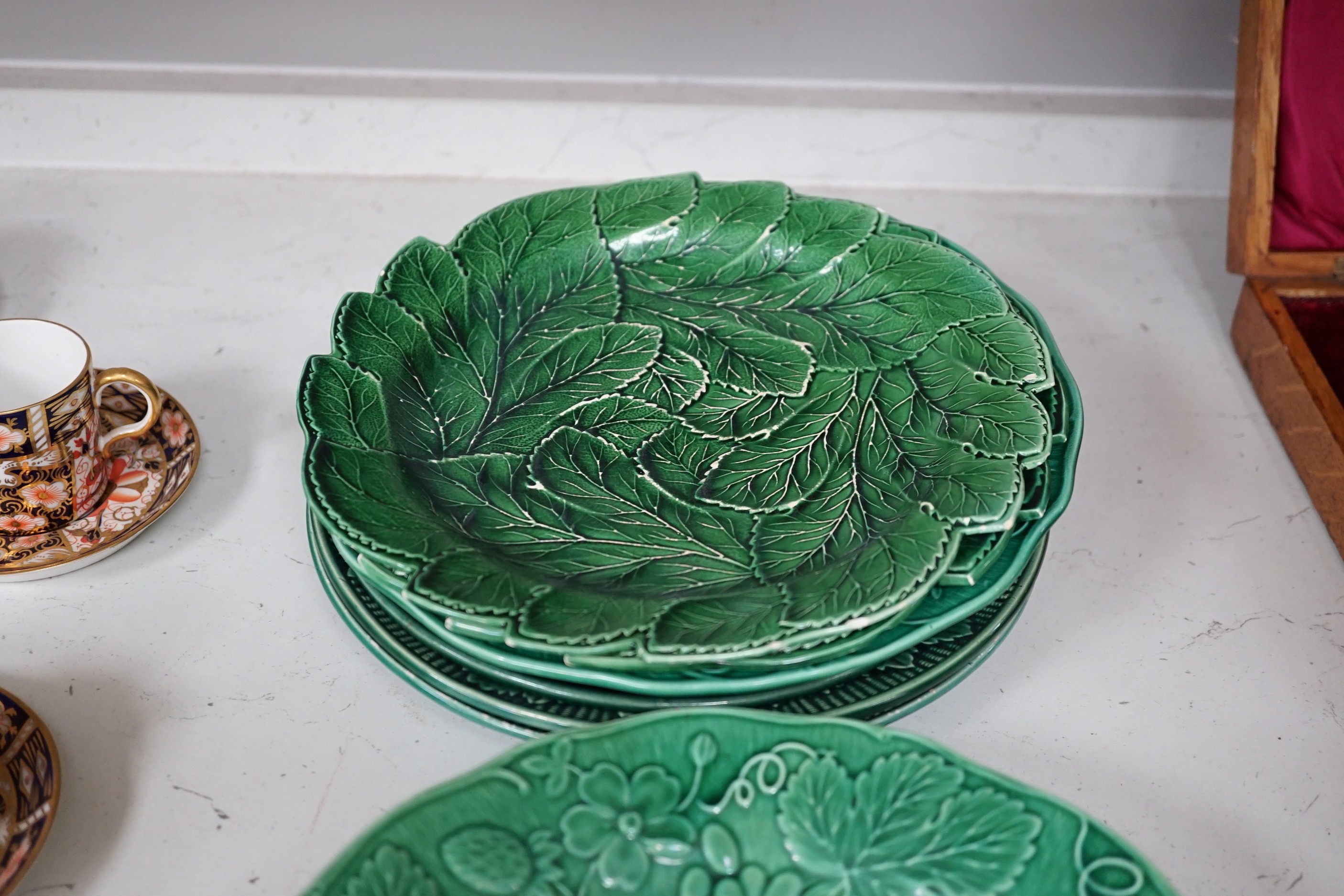 A collection of Victorian greenware leaf plates and dishes